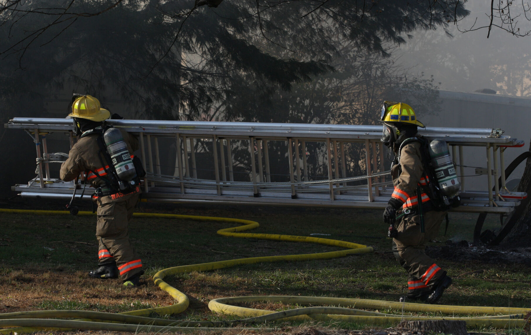 Firefighters carry ladder